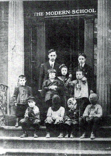 The NYC Modern School, ca. 1911–1912, Principal Will Durant and pupils. This photograph was the cover of the first issue of The Modern School magazine, public domain {{PD-US}}