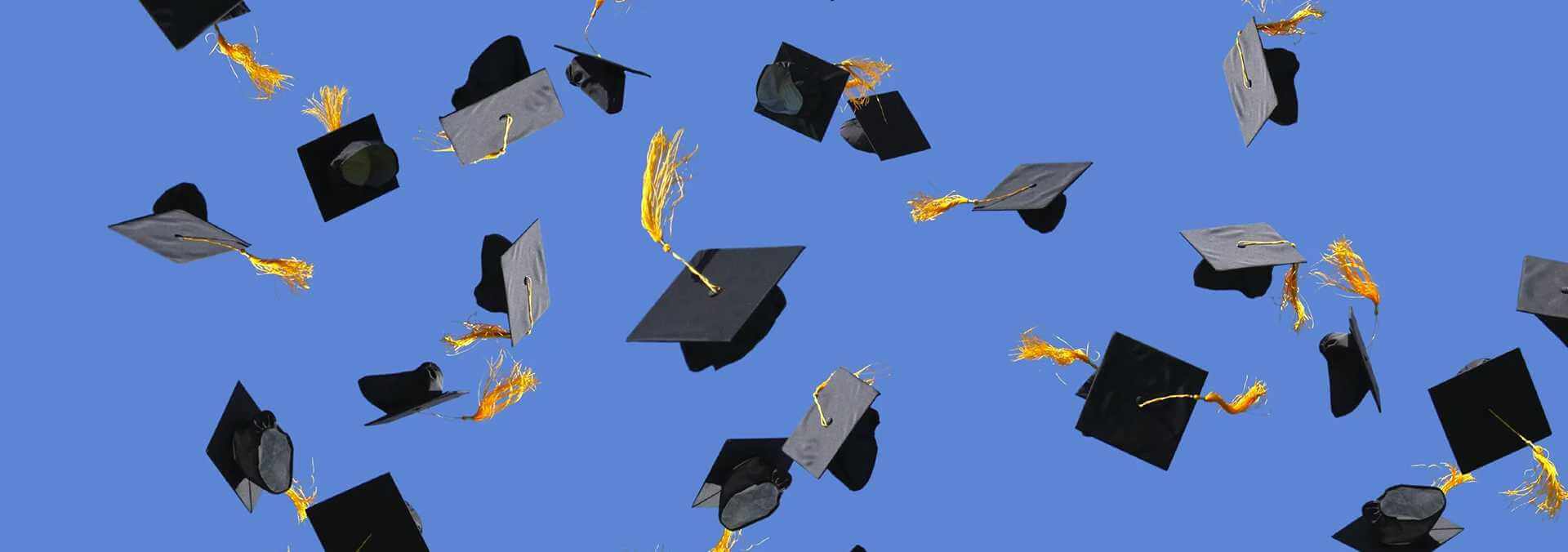 Graduation caps in the air