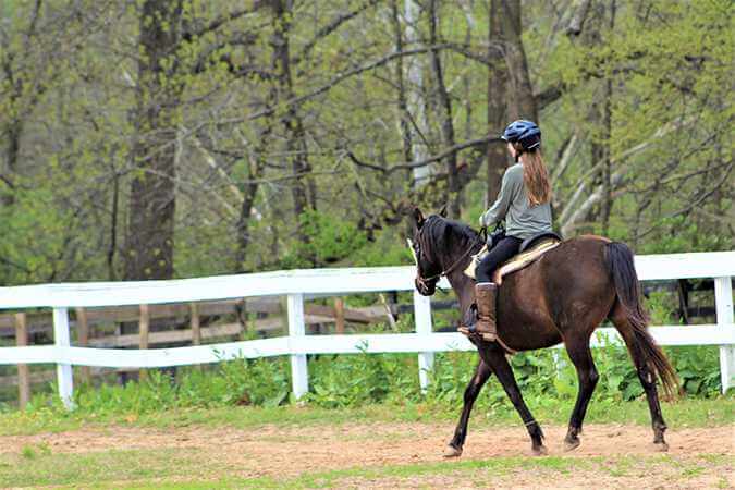 a young person horseback riding