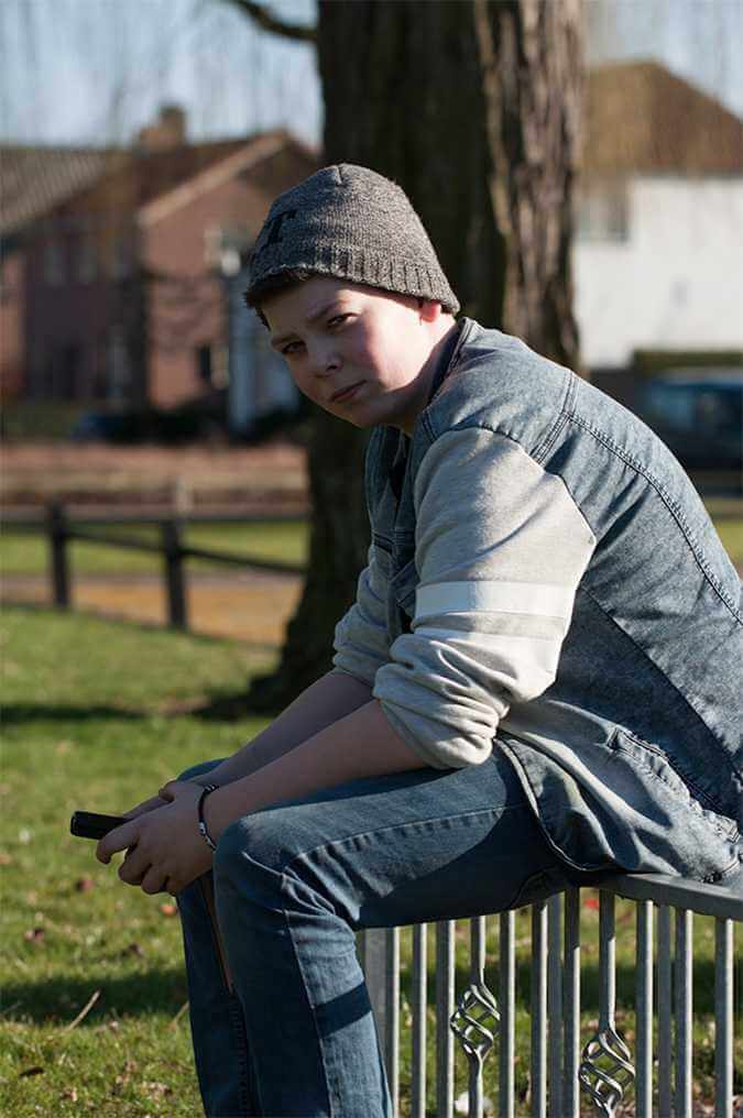 A teen on his smartphone