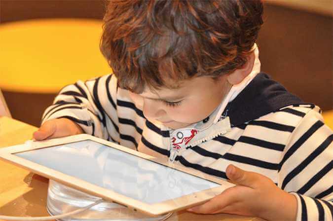 A child looking at a tablet device