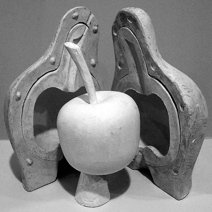 A rubber mold of the original wax model of an apple and its cast