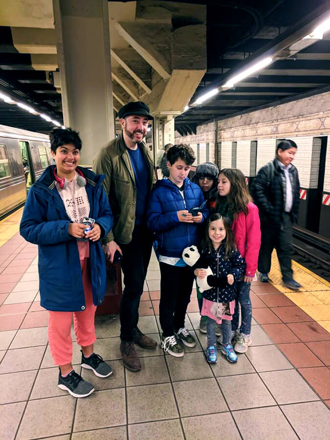 A group of people on a New York City subway platform