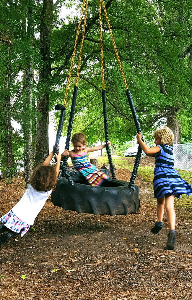 kids playing on a tire swing