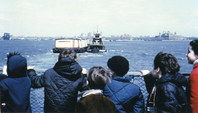 children staring out at boats