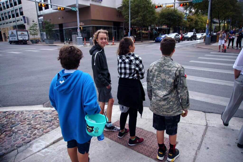 A group of young people crossing a street