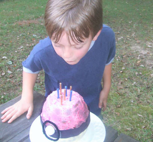 Child with PokéBall cake