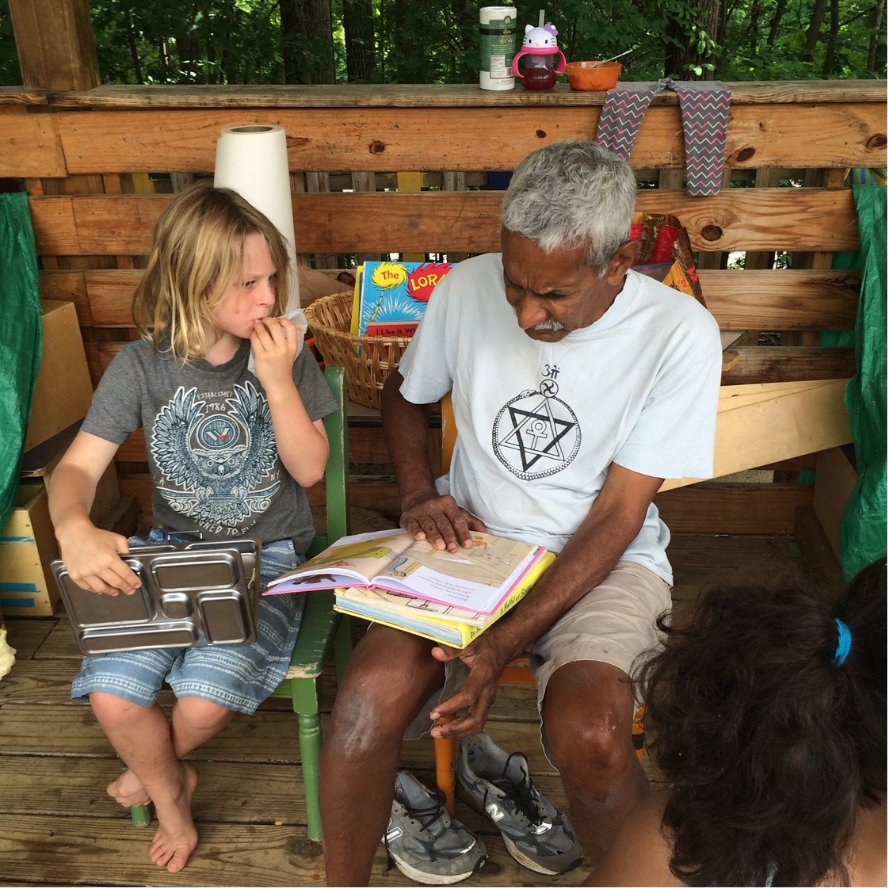 Luke listening to one of his facilitators, Miguel, read aloud to him at age 8.