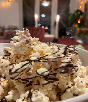 White popcorn with chocolate drizzle in a bowl