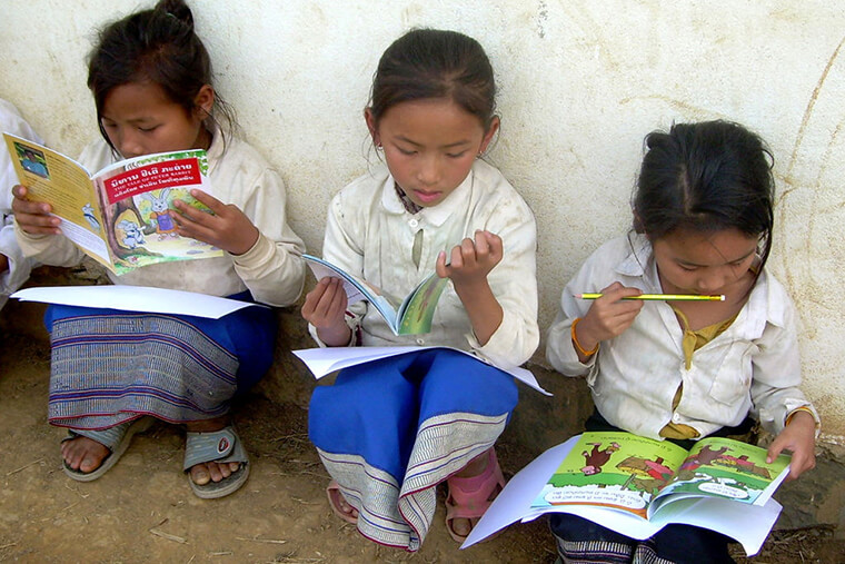 children reading in Laos